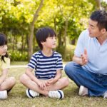 asian-father-and-children-talking-in-park
