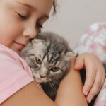 young+girl+cuddling+a+cat-min